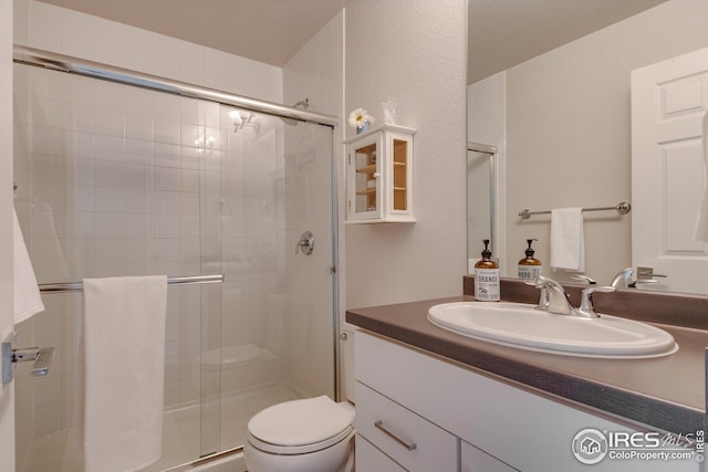1135 Hummingbird Cir, Longmont, CO 80501 - bathroom with vanity, a stall shower, and toilet