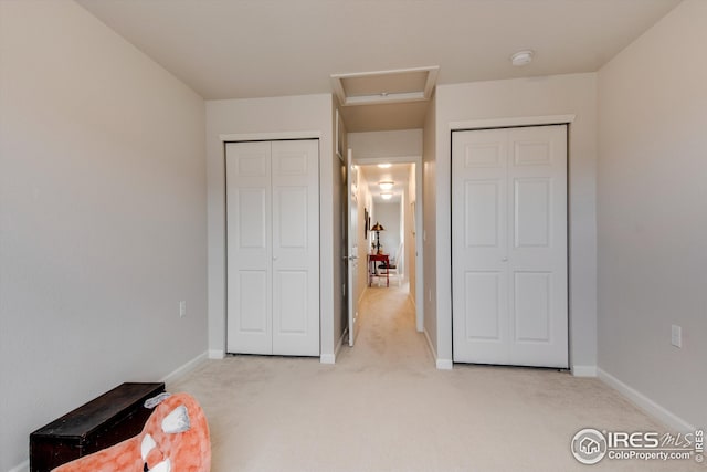 1135 Hummingbird Cir, Longmont, CO 80501 - bedroom featuring multiple closets, light colored carpet, and baseboards