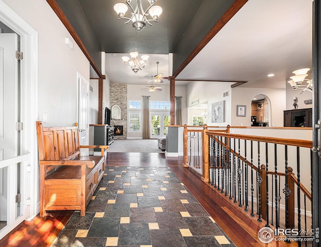 hallway with an inviting chandelier and dark wood-type flooring