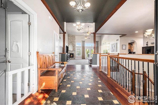 hallway featuring dark wood-type flooring and an inviting chandelier