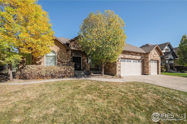 view of front of home with a front yard and a garage