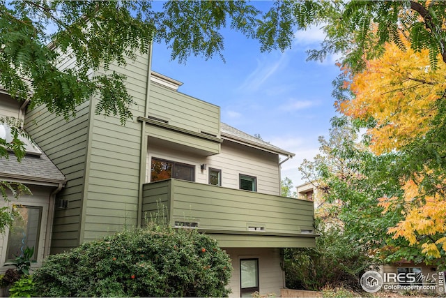 rear view of property with a balcony