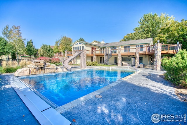 view of pool with a water slide