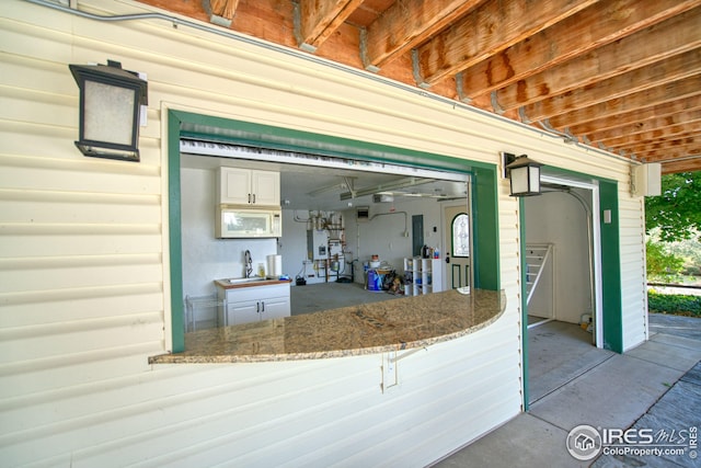 garage featuring water heater and sink