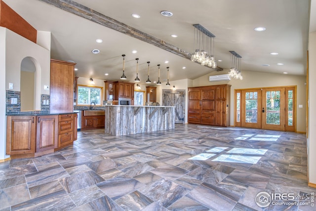 kitchen featuring french doors, a center island, hanging light fixtures, beamed ceiling, and a wall mounted AC