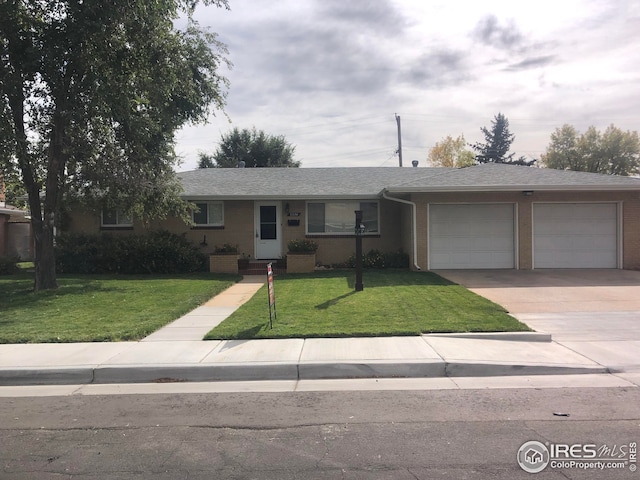 ranch-style house with a front yard and a garage