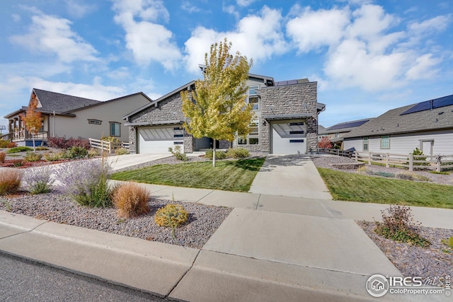 view of front of home with a garage and a front lawn