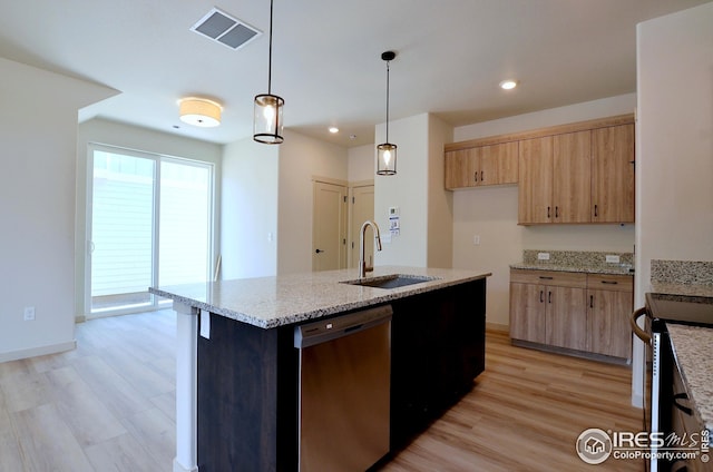 kitchen with light hardwood / wood-style floors, a center island with sink, stainless steel dishwasher, and sink