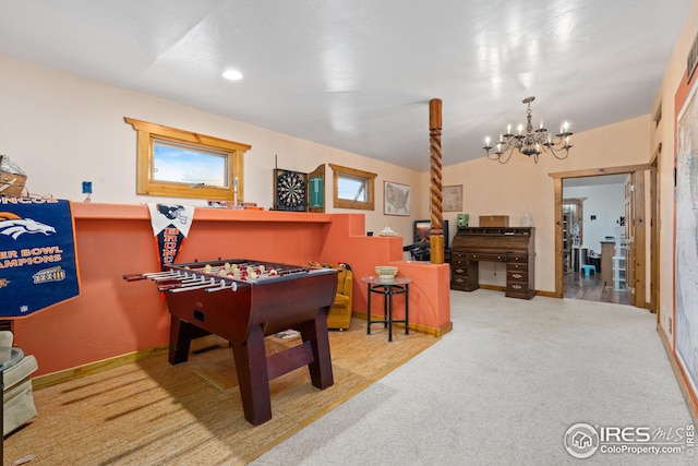 rec room featuring an inviting chandelier and carpet floors