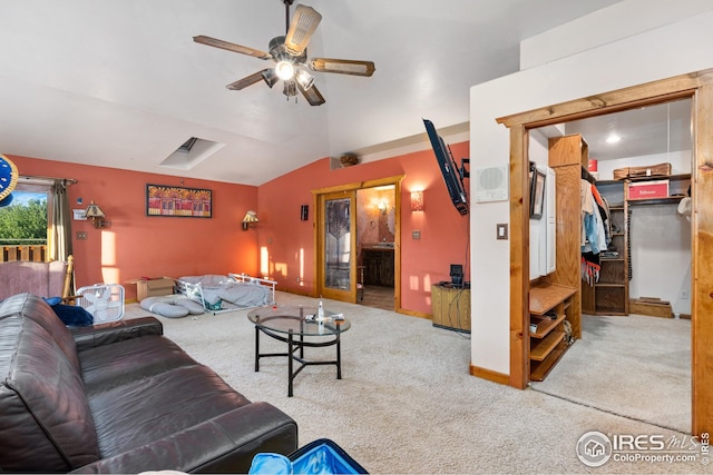 living area featuring lofted ceiling, ceiling fan, and carpet