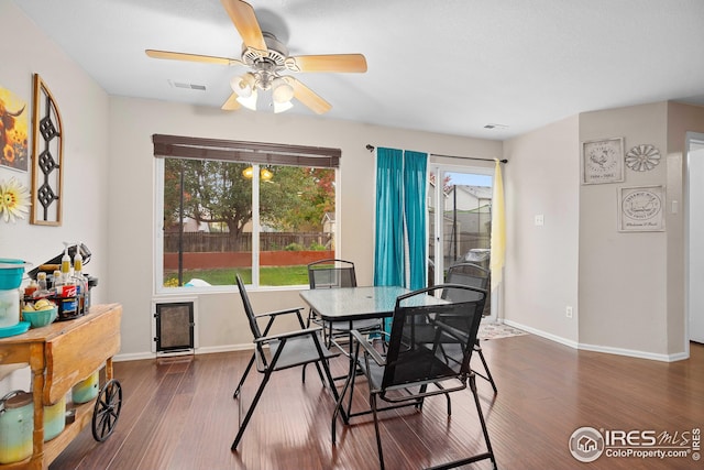 dining space featuring dark hardwood / wood-style floors and ceiling fan