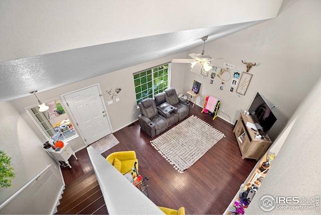 living room with ceiling fan, lofted ceiling, and dark hardwood / wood-style flooring