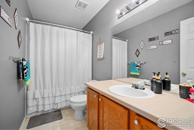 bathroom featuring vanity, toilet, walk in shower, and a textured ceiling