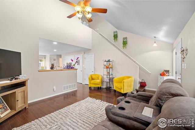 living room with vaulted ceiling, ceiling fan, and dark hardwood / wood-style flooring