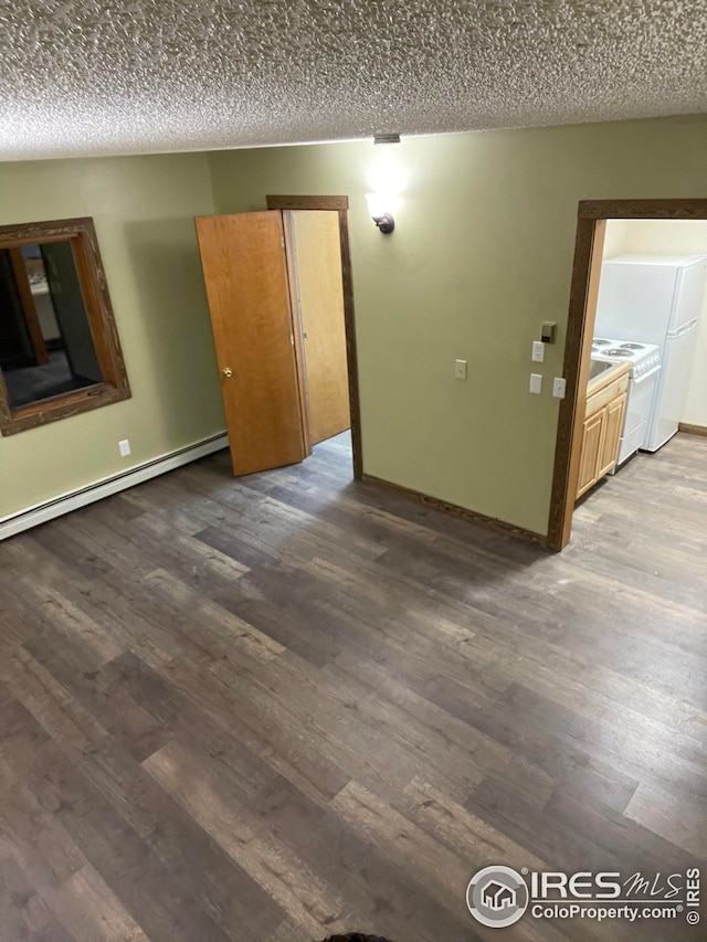 spare room with a baseboard heating unit, a textured ceiling, and wood-type flooring