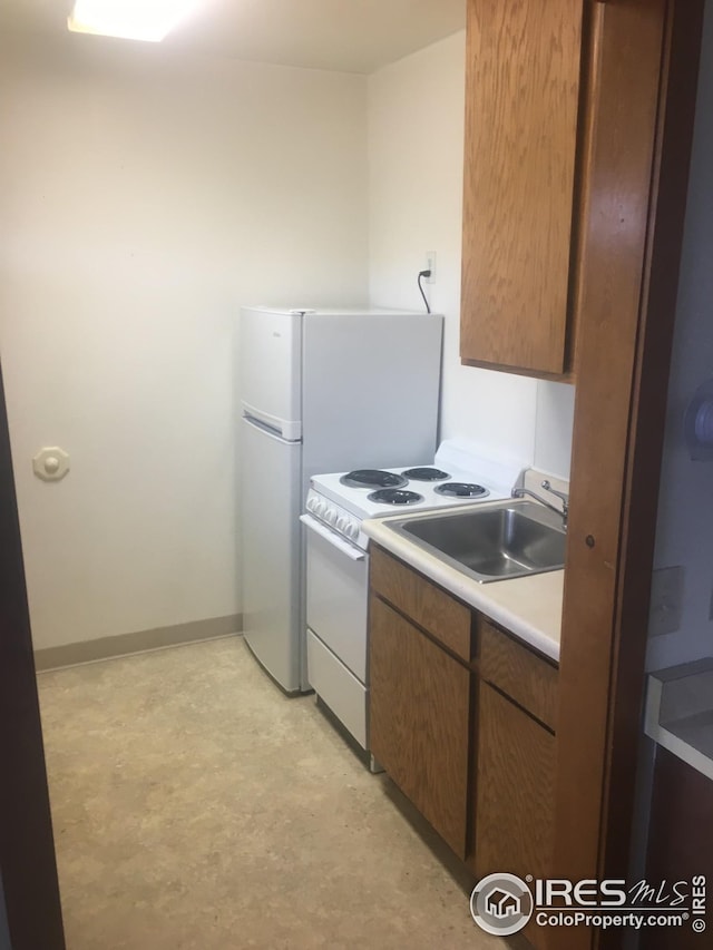 kitchen with electric stove and sink