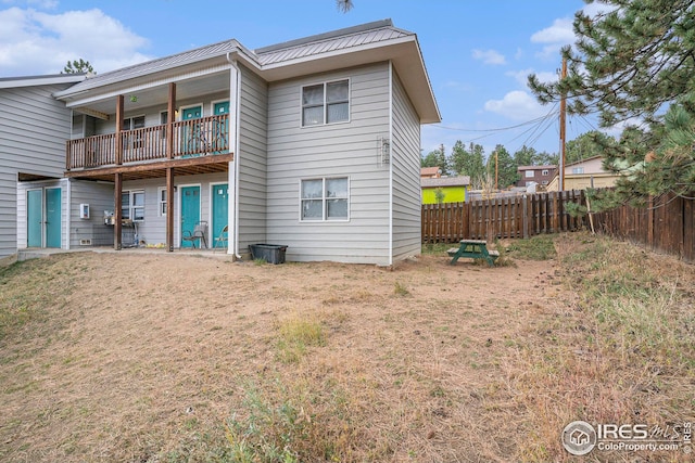 back of property featuring a balcony