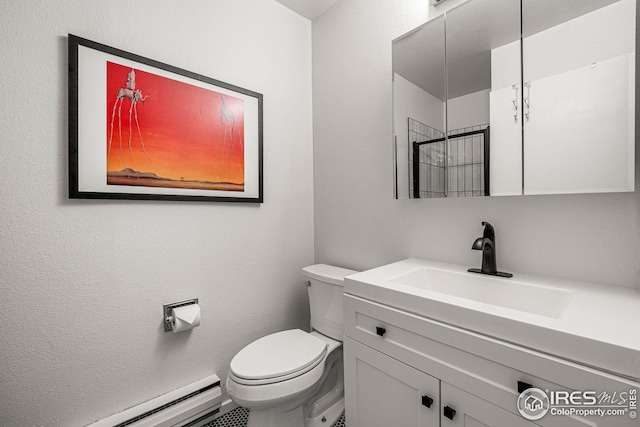 bathroom featuring toilet, vanity, and baseboard heating