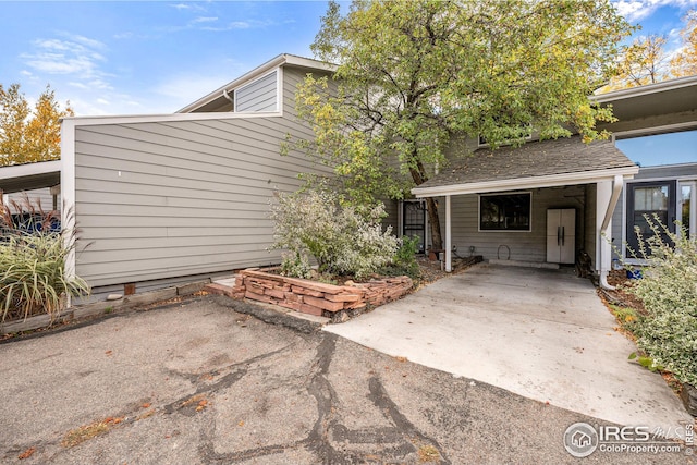 entrance to property featuring a carport