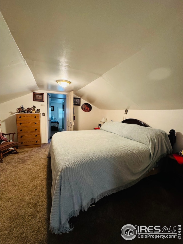 bedroom featuring carpet and vaulted ceiling