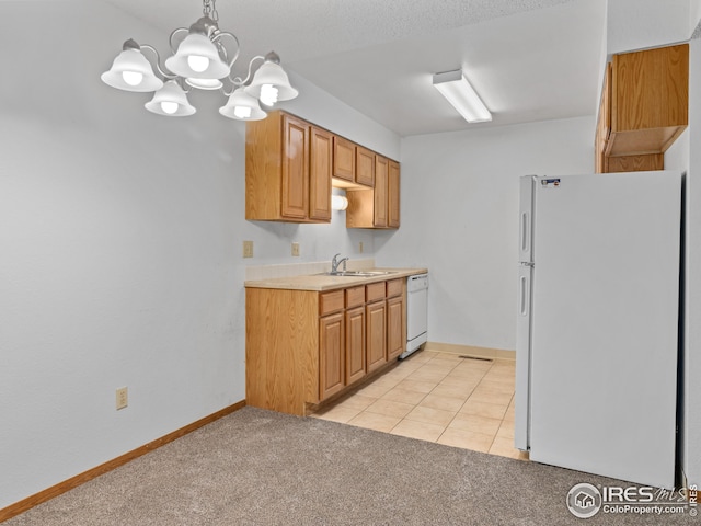 kitchen featuring sink, an inviting chandelier, light colored carpet, pendant lighting, and white appliances