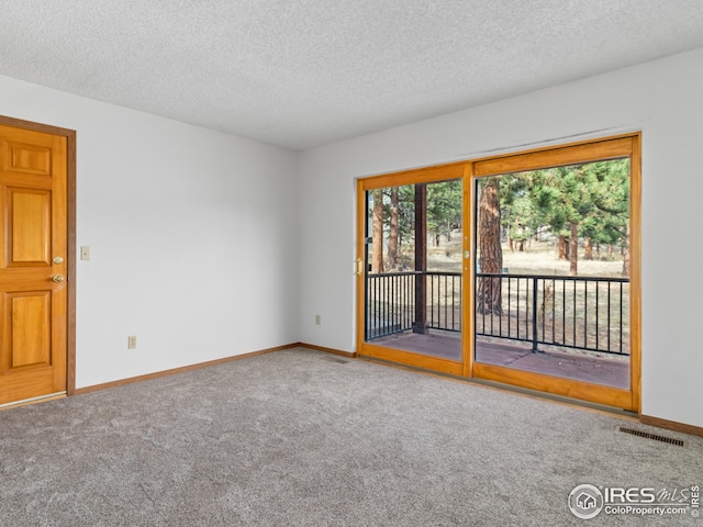 unfurnished room featuring carpet floors and a textured ceiling