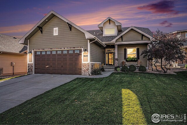 view of front facade featuring a lawn and a garage