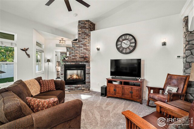 carpeted living room with lofted ceiling, a fireplace, and ceiling fan