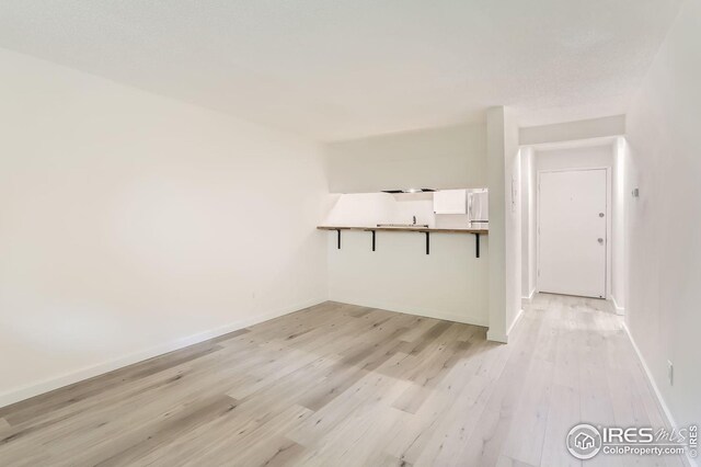 unfurnished room with light wood-type flooring