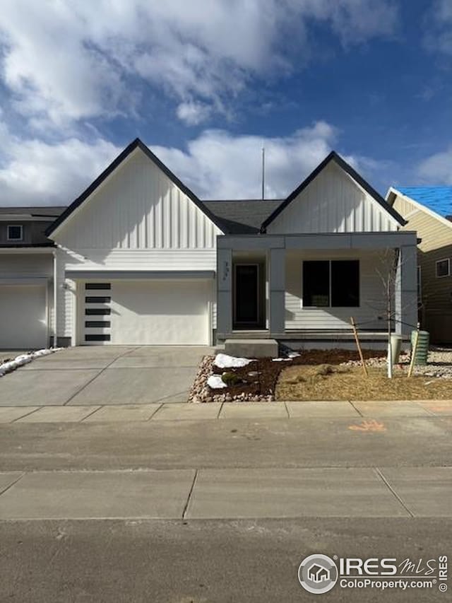 view of front of home with board and batten siding, concrete driveway, and a garage