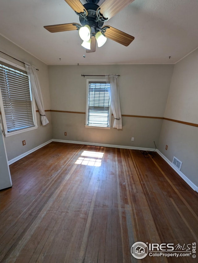 spare room with hardwood / wood-style flooring and ceiling fan