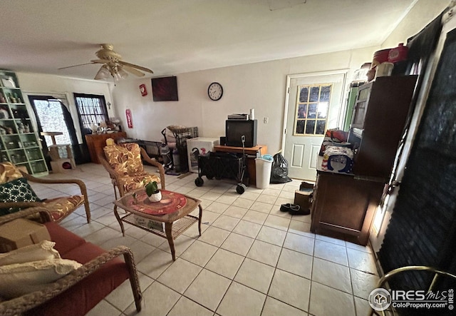 living room featuring light tile patterned flooring and ceiling fan