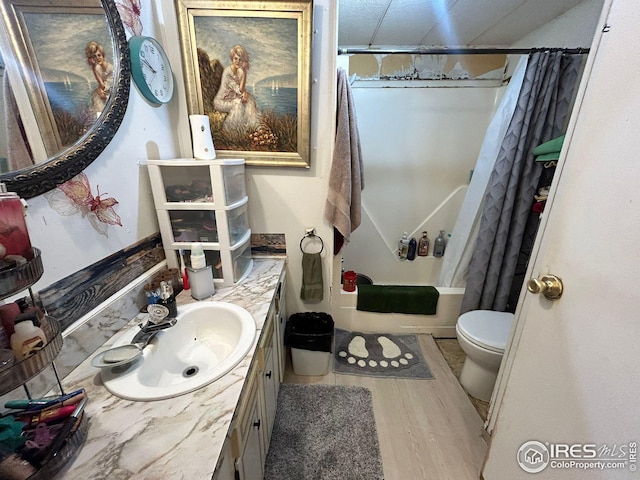 full bathroom featuring vanity, shower / bath combo, wood-type flooring, and toilet