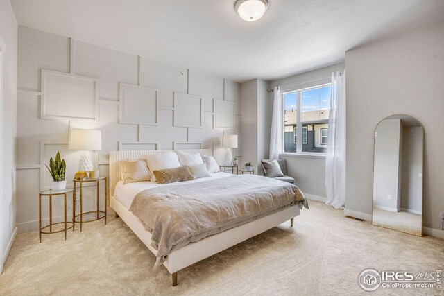 968 Birdwhistle Ln Unit 4, Fort Collins, CO 80524 - bedroom featuring visible vents, baseboards, and light carpet