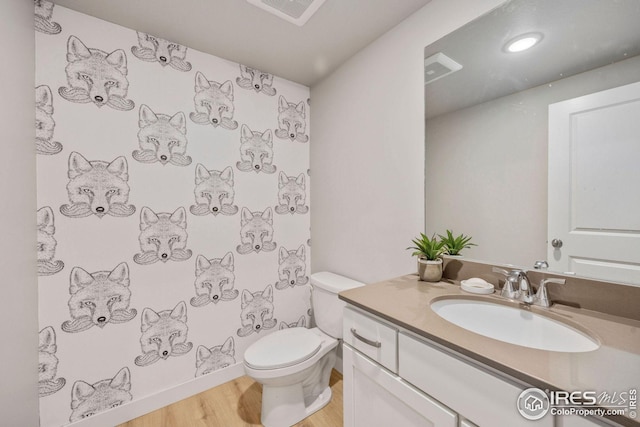968 Birdwhistle Ln Unit 4, Fort Collins, CO 80524 - full bathroom with vanity, toilet, visible vents, walk in shower, and wood finished floors