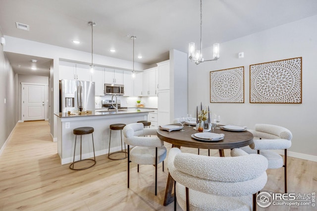 968 Birdwhistle Ln Unit 4, Fort Collins, CO 80524 - dining room with light wood-style flooring, visible vents, baseboards, an inviting chandelier, and recessed lighting