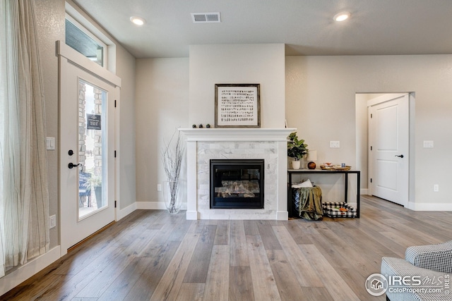 968 Birdwhistle Ln Unit 3, Fort Collins, CO 80524 - living area with visible vents, wood finished floors, a wealth of natural light, and a premium fireplace