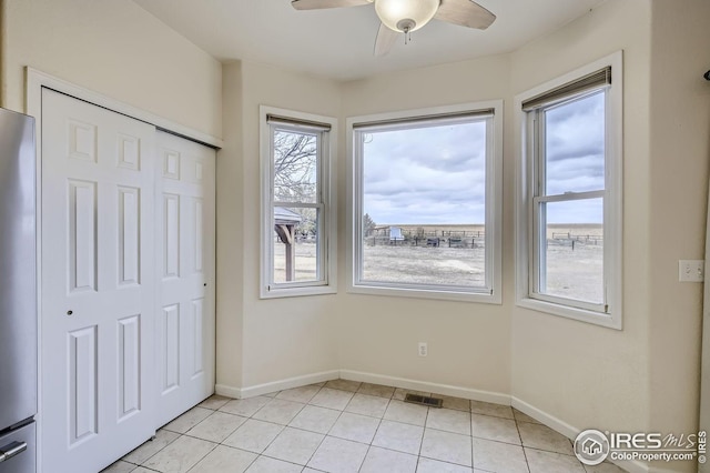interior space featuring a closet, light tile patterned flooring, visible vents, and baseboards