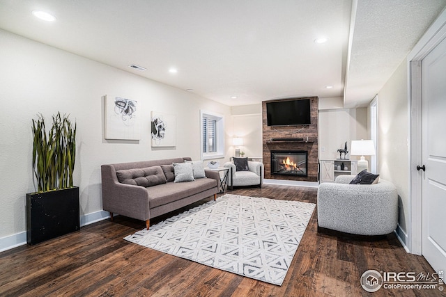 living area with recessed lighting, a large fireplace, wood finished floors, visible vents, and baseboards