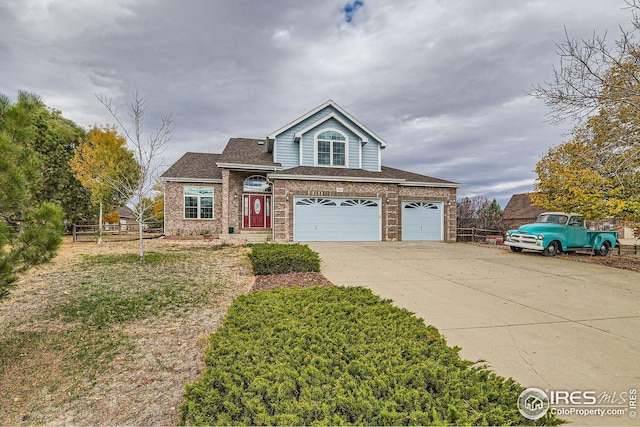 view of front of home with a shingled roof, fence, concrete driveway, and brick siding
