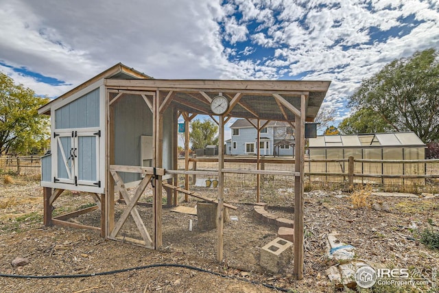 view of poultry coop featuring fence