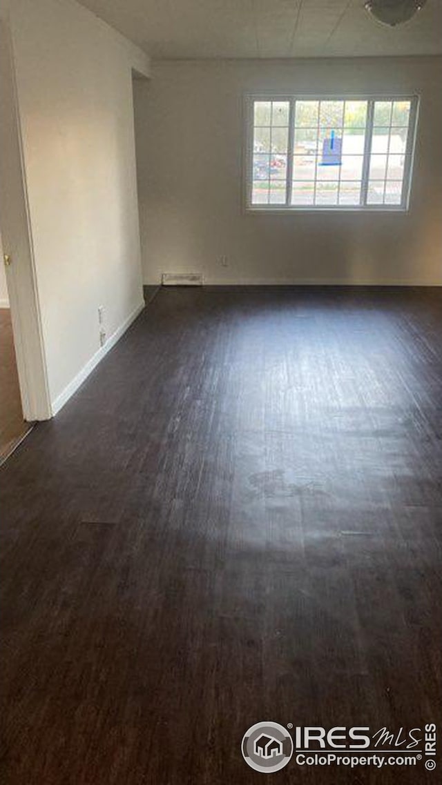 spare room with dark hardwood / wood-style flooring