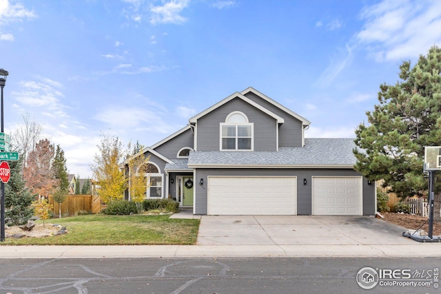 view of front property featuring a front lawn and a garage