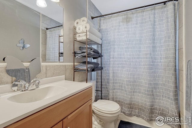 bathroom featuring vanity, curtained shower, and toilet