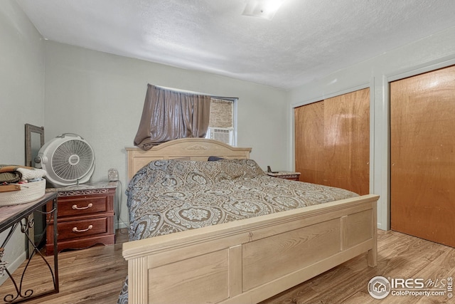 bedroom featuring hardwood / wood-style floors and a textured ceiling