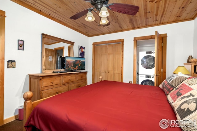 carpeted bedroom featuring wood ceiling, a closet, stacked washer and dryer, and ceiling fan