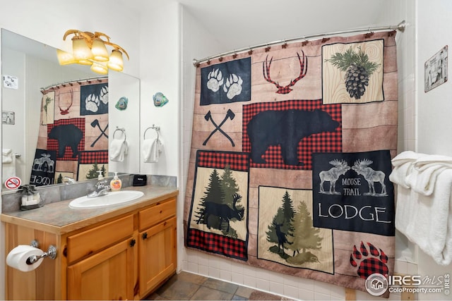 bathroom featuring vanity, walk in shower, and tile patterned flooring