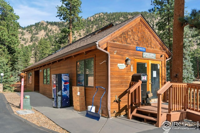 log-style house featuring a deck with mountain view