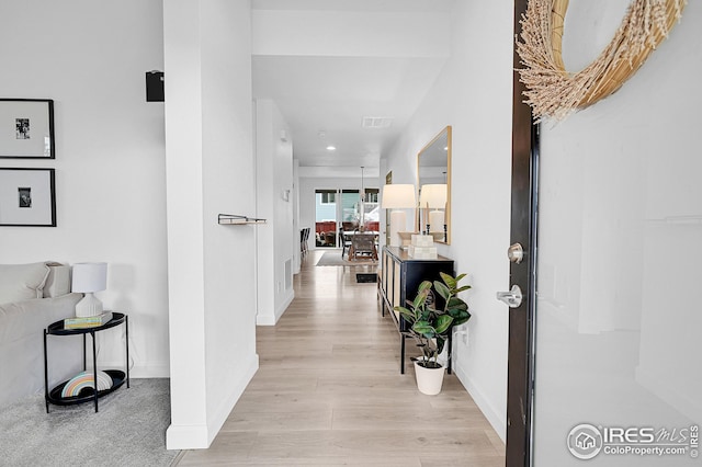 hallway with light hardwood / wood-style flooring