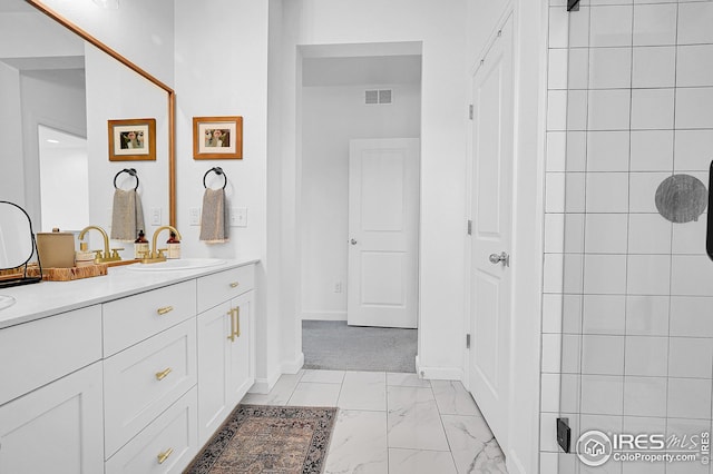 bathroom featuring vanity and tiled shower